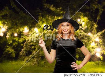 woman in halloween costume of witch with accessory 69814977