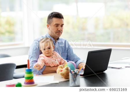 father with baby working at home office 69815169