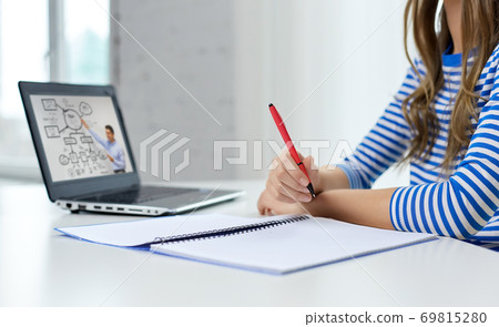 student girl with exercise book, pen and laptop 69815280