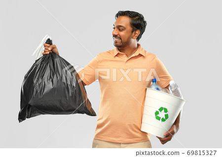 smiling indian man sorting paper and plastic waste smiling indian man sorting paper and plastic waste 69815327