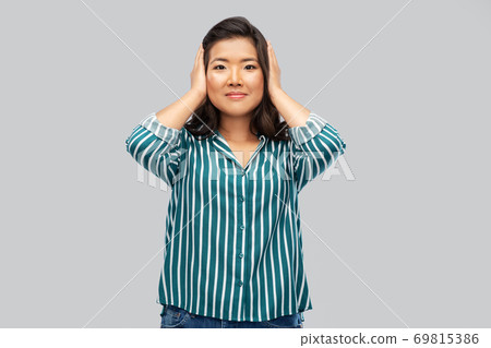 asian woman closing ears by hands 69815386