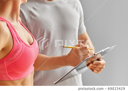close up of woman with personal trainer in gym close up of woman with personal trainer in gym 69815429