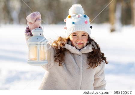 happy little girl with christmas lantern in winter happy little girl with christmas lantern in winter 69815597