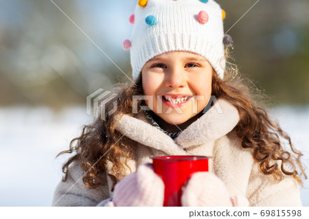 little girl with cup of hot tea in winter park little girl with cup of hot tea in winter park 69815598