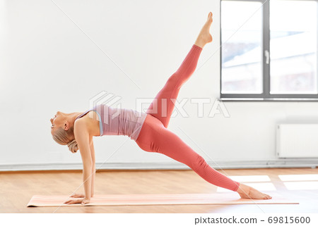 young woman doing yoga upward plank pose at studio young woman doing yoga upward plank pose at studio 69815600