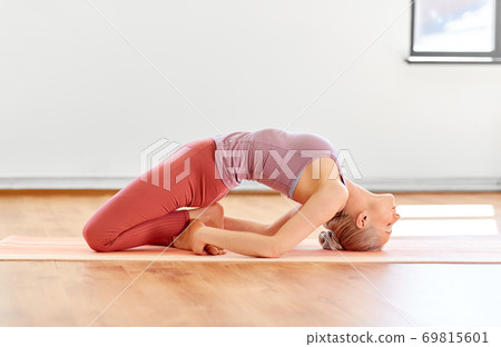young woman doing fish pose at yoga studio 69815601