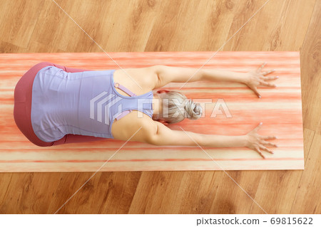 woman doing yoga child pose at studio 69815622