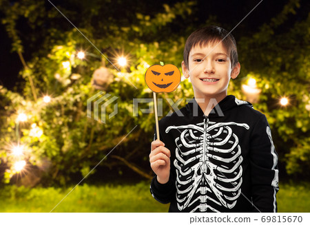 boy in halloween costume of skeleton with pumpkin boy in halloween costume of skeleton with pumpkin 69815670