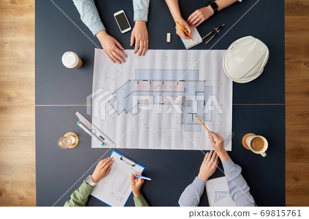 business team with blueprint working at office business team with blueprint working at office 69815761
