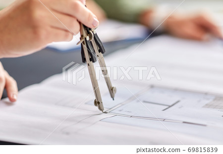 architect with blueprint and drafting compass architect with blueprint and drafting compass 69815839