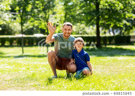 happy smiling father and little son at summer park happy smiling father and little son at summer park 69815845