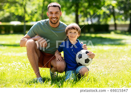 father and little son with soccer ball at park father and little son with soccer ball at park 69815847