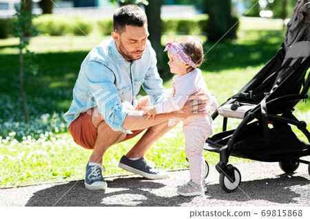 happy father with child in stroller at summer park 69815868