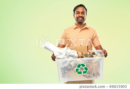 smiling young indian man sorting paper waste 69815903
