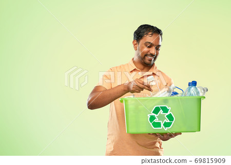 smiling young indian man sorting plastic waste smiling young indian man sorting plastic waste 69815909