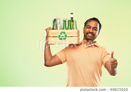 smiling young indian man sorting glass waste smiling young indian man sorting glass waste 69815910