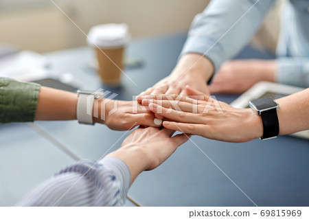 close up of business team stacking hands 69815969