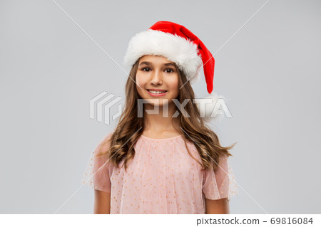 happy teenage girl in santa hat on christmas happy teenage girl in santa hat on christmas 69816084