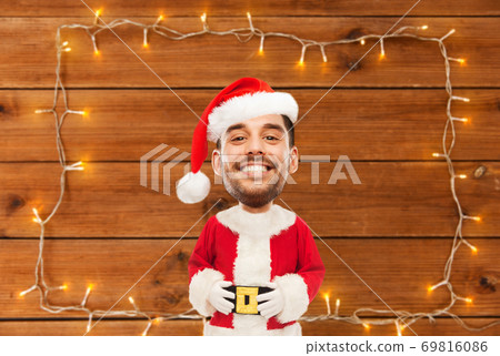happy santa over garland on wooden background happy santa over garland on wooden background 69816086