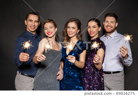 happy friends in party clothes with sparklers 69816275