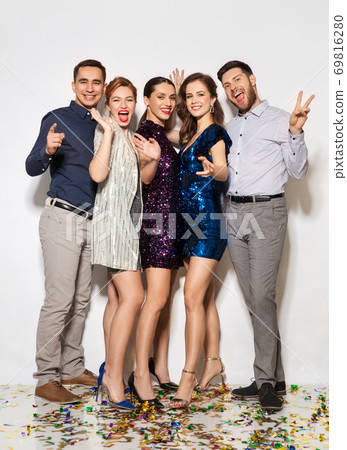 happy friends at party with confetti on floor happy friends at party with confetti on floor 69816280