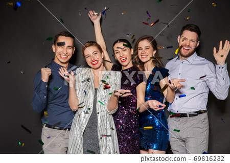 happy friends at party under confetti over black happy friends at party under confetti over black 69816282