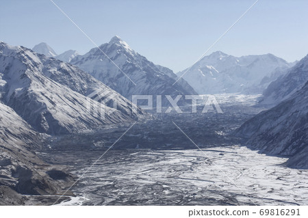 Mountain valley, the river and the body of the glacier in the February snow. Mountain valley, the river and the body of the glacier in the February snow. 69816291