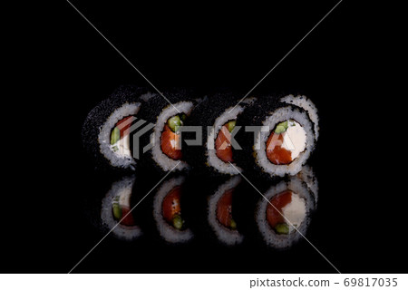 Fresh delicious beautiful sushi rolls on a dark background 69817035