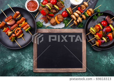 Grilled kebabs with meat, mushrooms and vegetables 69818313