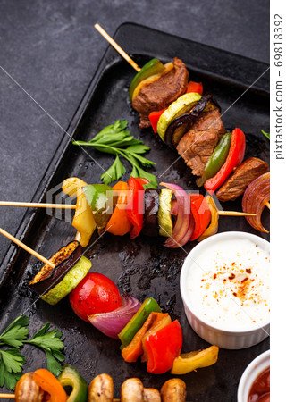 Grilled kebabs with meat, mushrooms and vegetables Grilled kebabs with meat, mushrooms and vegetables 69818392