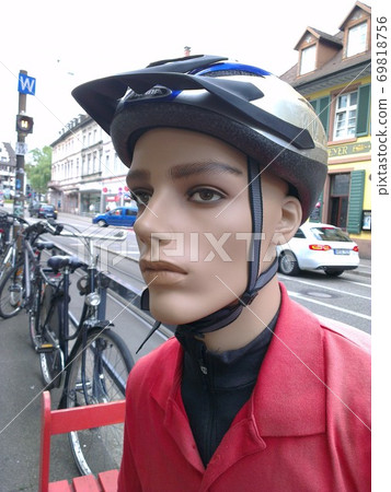 Cyclist (mannequin with neutral face) wearing a protective equipment (cycling helmet) Cyclist (mannequin with neutral face) wearing a protective equipment (cycling helmet) 69818756