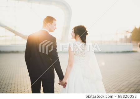 Wedding couple bride and groom holding hands Wedding couple bride and groom holding hands 69820058