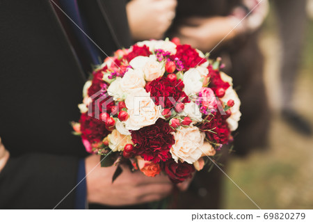 Wonderful luxury wedding bouquet of different flowers Wonderful luxury wedding bouquet of different flowers 69820279