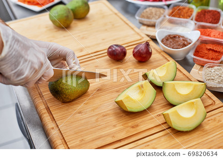 Fresh ingredients for salad or dip making: avocado, tomatoes,nuts,oil on rustic background, top view, place for text. Healthy food and cooking concept Fresh ingredients for salad or dip making: avocado, tomatoes,nuts,oil on rustic background, top view, place for text. Healthy food and cooking concept 69820634
