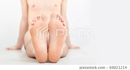 Men a foot and a heel on a gray background. 69821214