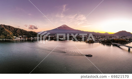 Aerial view over lake Kawaguchi, located in the border Fujikawaguchiko and Minobu, southern Yamanashi Prefecture near Mount Fuji, Japan. Lake Kawaguchi is a very popular tourist spot near Fuji Japan. Aerial view over lake Kawaguchi, located in the border Fujikawaguchiko and Minobu, southern Yamanashi Prefecture near Mount Fuji, Japan. Lake Kawaguchi is a very popular tourist spot near Fuji Japan. 69821570