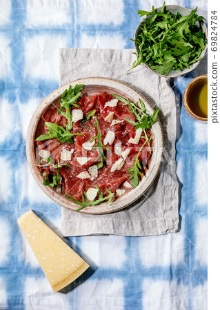 Beef carpaccio, cheese and arugula 69824784