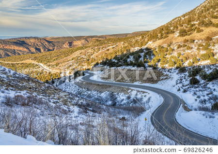 scenic windy mountain road in winter scenery 69826246