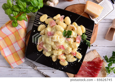 Gnocchi with prosciutto ham and cheese sauce Gnocchi with prosciutto ham and cheese sauce 69826745