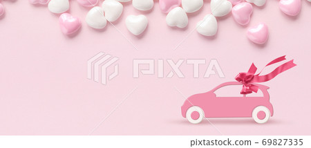 Pink car with gift bow on a pink background with hearts Pink car with gift bow on a pink background with hearts 69827335
