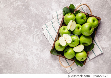 Ripe green apples in wooden box. 69827678