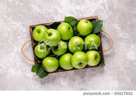 Ripe green apples in wooden box. Ripe green apples in wooden box. 69827682
