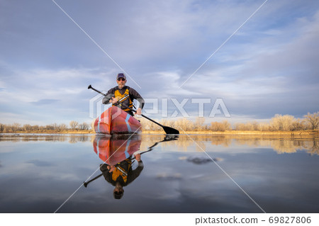 senior male paddling stand up paddleboard senior male paddling stand up paddleboard 69827806