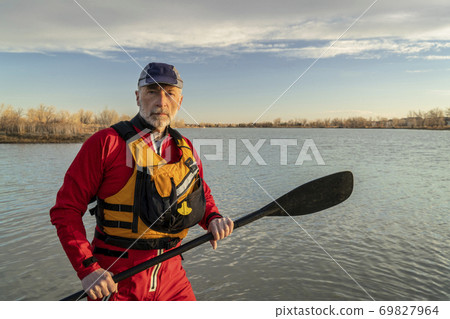 environmental portrait of a senior male paddler in a drysuit environmental portrait of a senior male paddler in a drysuit 69827964