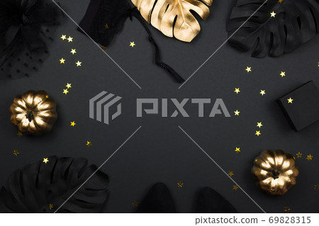 Halloween party collection female outfit accessories on black background: hat with veil, garter belt, gifts. Black and gold pumpkins, flat lay, top view, copy space. Halloween party collection female outfit accessories on black background: hat with veil, garter belt, gifts. Black and gold pumpkins, flat lay, top view, copy space. 69828315