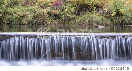 Water cascading over a river diversion dam Water cascading over a river diversion dam 69828446