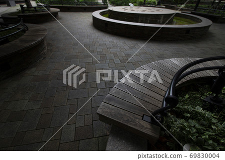 An empty bench in an urban square An empty bench in an urban square 69830004