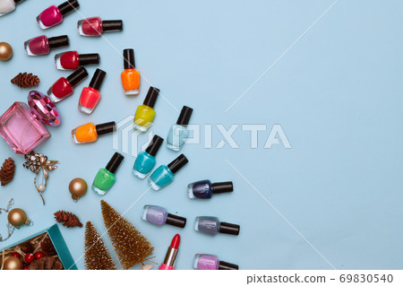 christmas concept, new year, manicure with nail polish, pedicure on blue background, copy space, Flat Lay 69830540