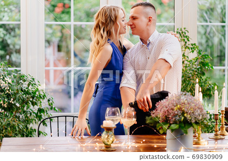 couple on romantic dinner. guy pours champagne. couple on romantic dinner. guy pours champagne. 69830909