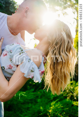 beautiful and happy couple having fun in garden. beautiful and happy couple having fun in garden. 69831103